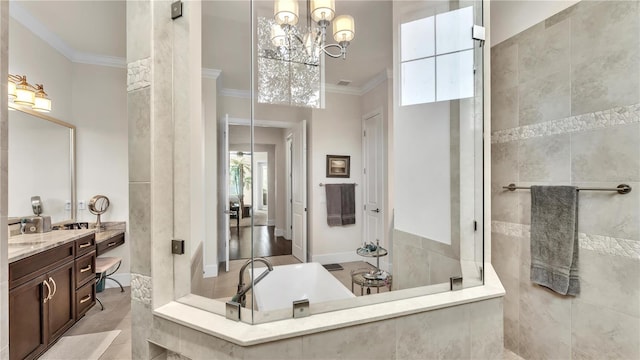 bathroom featuring ornamental molding, tiled shower, vanity, and an inviting chandelier