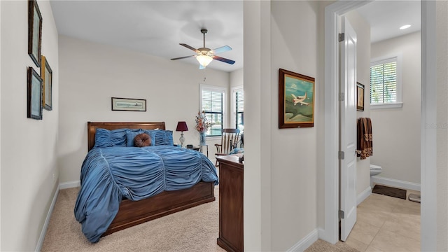 bedroom with connected bathroom, ceiling fan, and light tile patterned floors