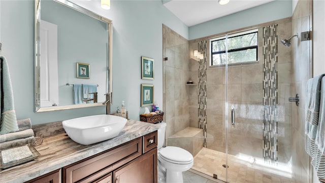 bathroom featuring walk in shower, vanity, and toilet