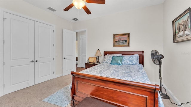 carpeted bedroom featuring a closet and ceiling fan