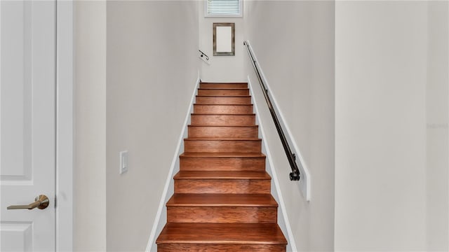 stairway with hardwood / wood-style flooring