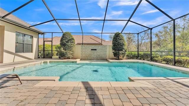 view of swimming pool with glass enclosure