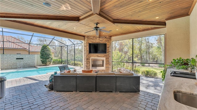 view of patio / terrace featuring sink and an outdoor living space with a fireplace