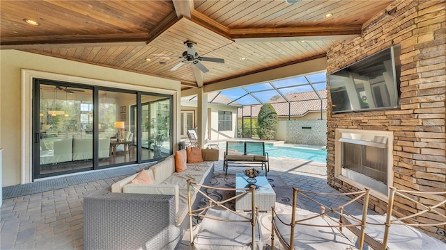 view of patio / terrace with an outdoor living space with a fireplace, a lanai, and ceiling fan