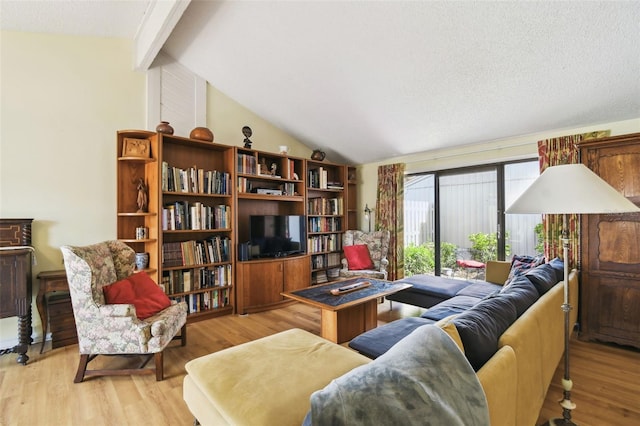 living room with light wood-type flooring and vaulted ceiling with beams