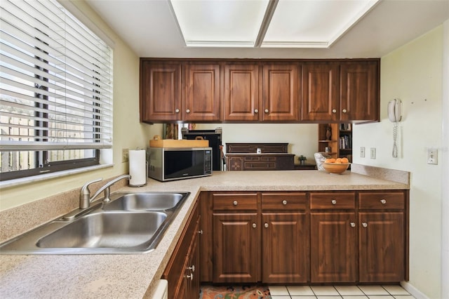 kitchen featuring sink and light tile patterned floors