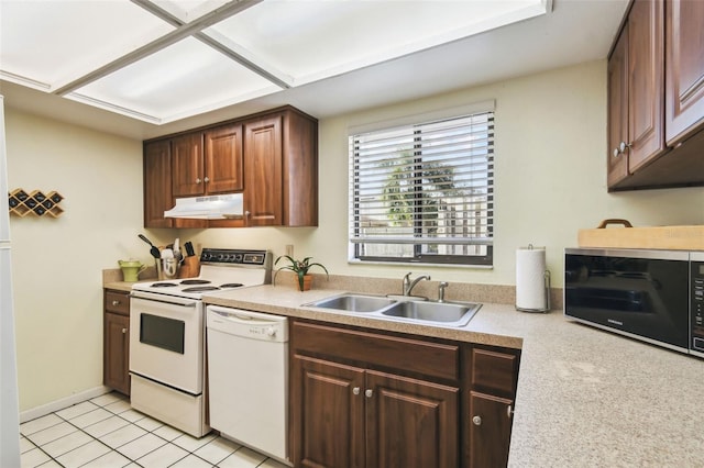 kitchen featuring sink, light tile patterned floors, and white appliances