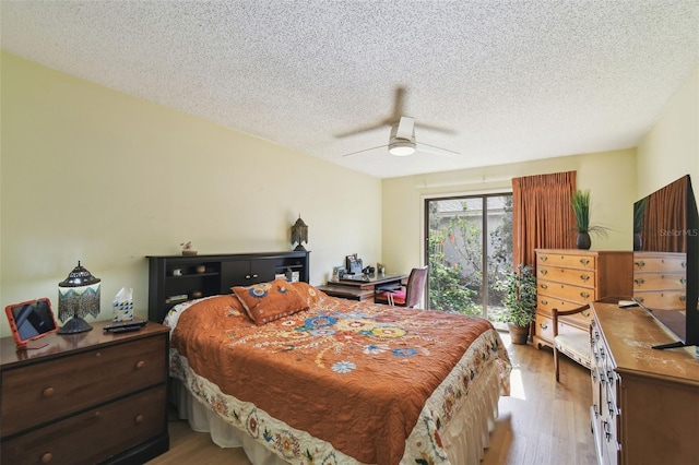 bedroom featuring a textured ceiling, ceiling fan, and light wood-type flooring