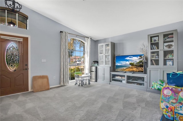 interior space featuring vaulted ceiling and carpet