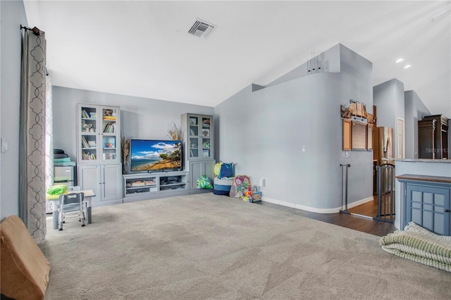 carpeted living room with vaulted ceiling