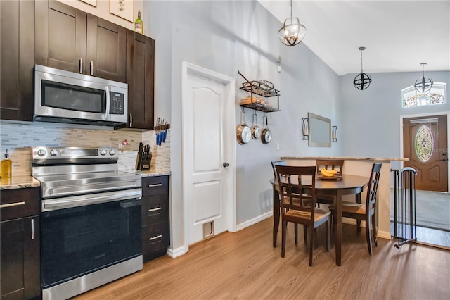 kitchen with pendant lighting, dark brown cabinets, and stainless steel appliances