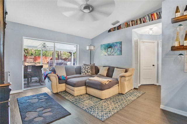 living room featuring vaulted ceiling, hardwood / wood-style floors, and ceiling fan