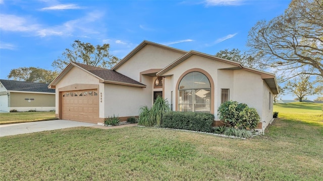 view of front of property featuring a garage and a front yard