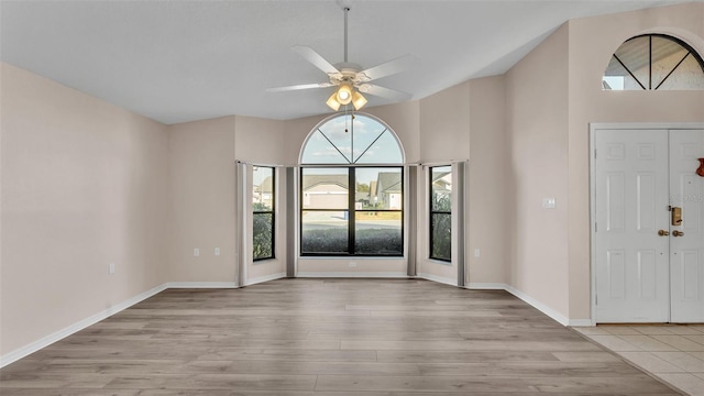 entryway featuring high vaulted ceiling, ceiling fan, and light hardwood / wood-style flooring