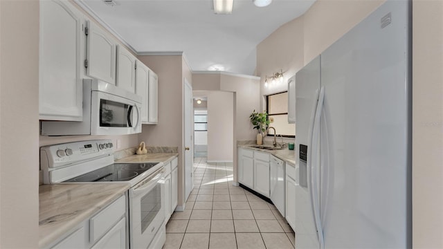 kitchen with sink, white appliances, light tile patterned floors, light stone counters, and white cabinets