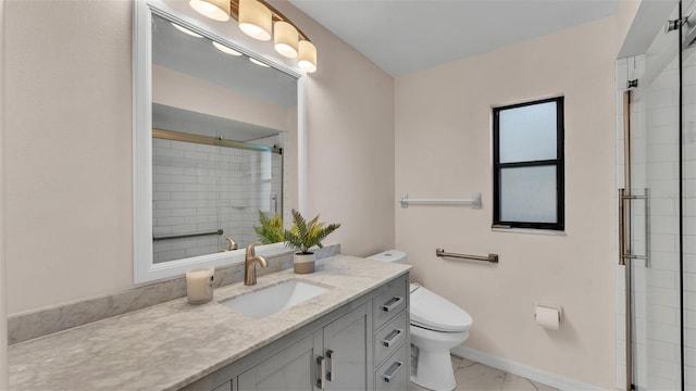 bathroom with vanity, a shower with shower door, and toilet