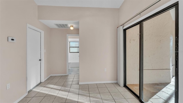 hall featuring light tile patterned floors