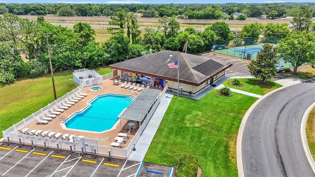 view of swimming pool featuring a patio and a yard