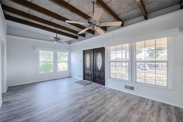 entrance foyer featuring vaulted ceiling with beams, hardwood / wood-style floors, and ceiling fan