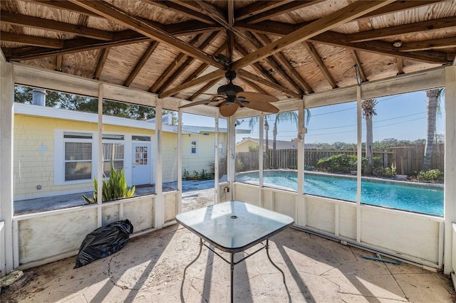 unfurnished sunroom featuring lofted ceiling and ceiling fan