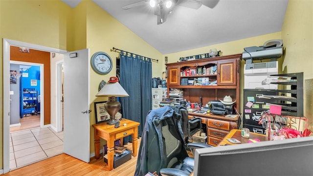 office space with light tile patterned floors, ceiling fan, and vaulted ceiling