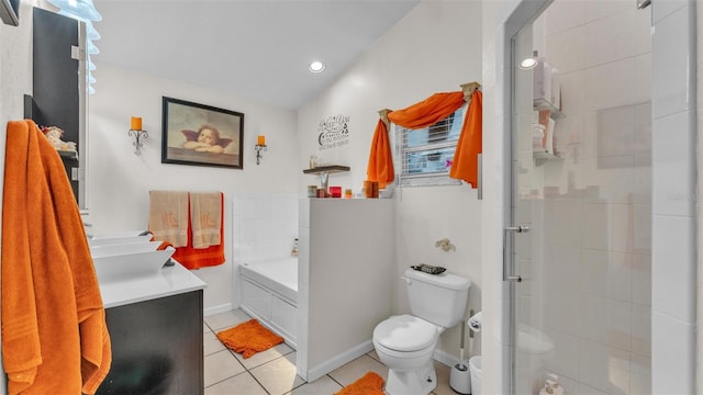 bathroom featuring tile patterned floors, toilet, vanity, a shower stall, and a bath