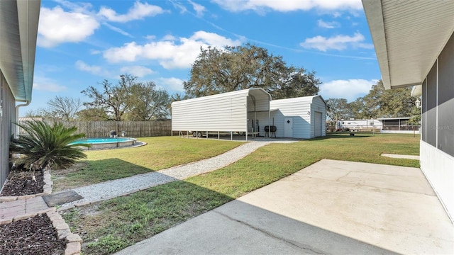 view of yard featuring a shed, an outdoor structure, fence, and a fenced in pool