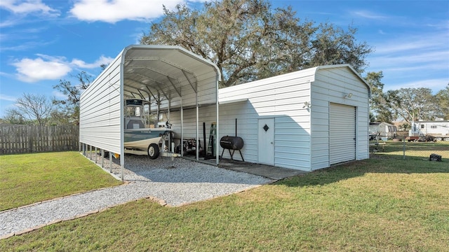 view of outbuilding featuring driveway, an outdoor structure, and fence