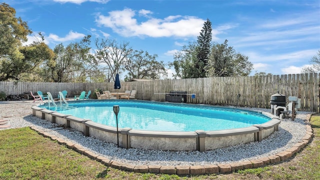 view of pool featuring a fenced in pool and a fenced backyard