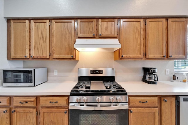 kitchen with extractor fan and stainless steel appliances