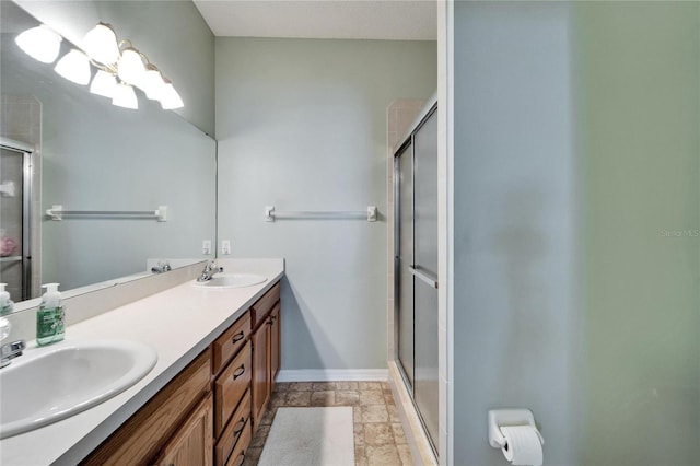 bathroom featuring vanity and a shower with shower door