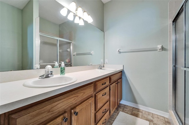 bathroom with vanity and a shower with shower door