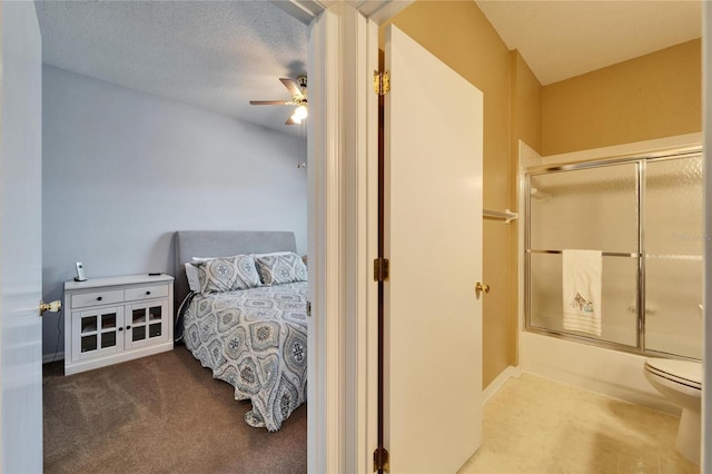 bedroom featuring ceiling fan, carpet floors, and a textured ceiling