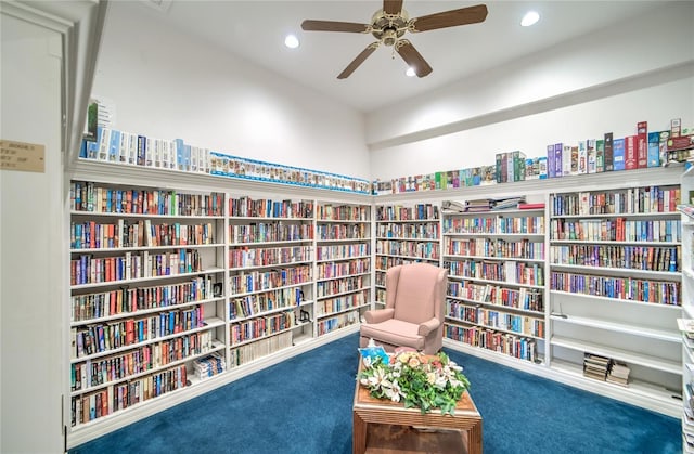 living area featuring ceiling fan and carpet flooring