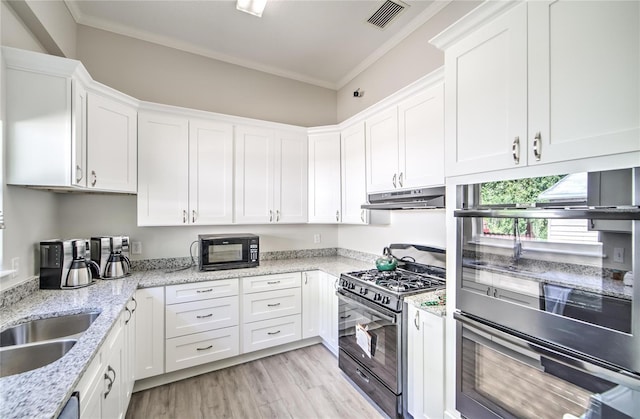 kitchen with stainless steel appliances, white cabinetry, and crown molding