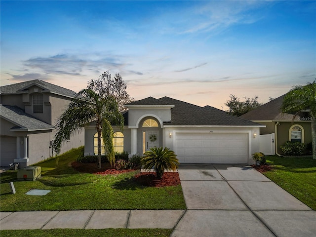 3961 Hampton Hills Dr W, Lakeland, FL 33810 - ranch-style house featuring a garage and a lawn