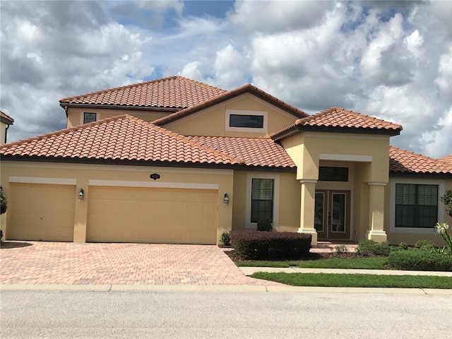 mediterranean / spanish-style house with a garage