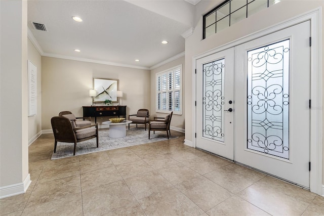 entrance foyer featuring ornamental molding, light tile patterned floors, and french doors