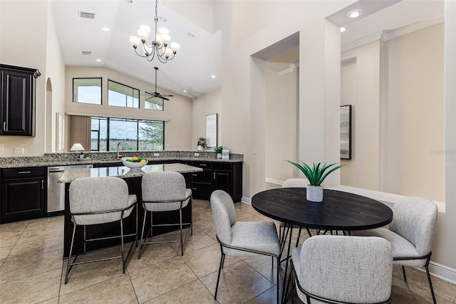 kitchen with hanging light fixtures, light stone counters, a notable chandelier, stainless steel dishwasher, and kitchen peninsula