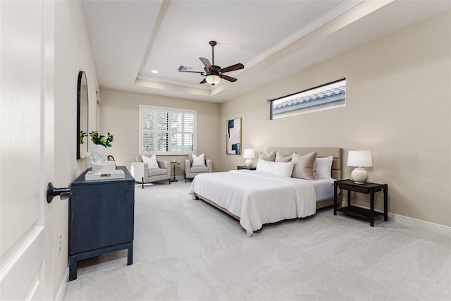 carpeted bedroom featuring ceiling fan and a raised ceiling