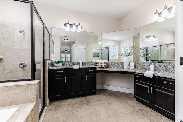 bathroom featuring vanity, ceiling fan, a shower with shower door, and a healthy amount of sunlight