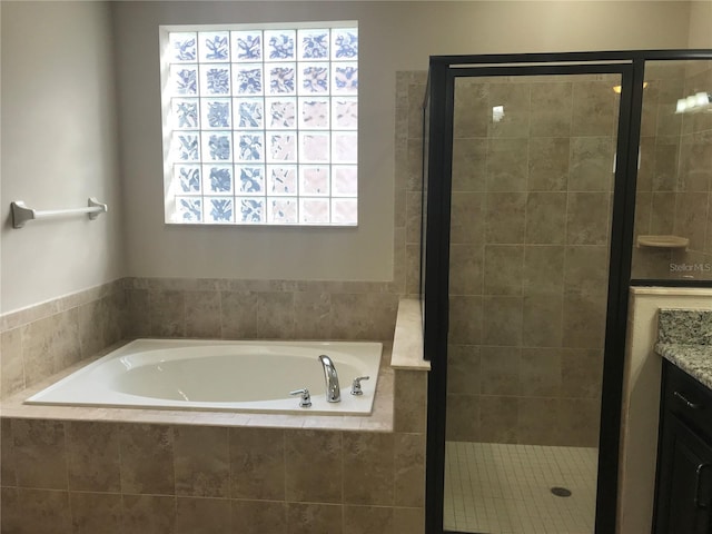 bathroom with vanity and independent shower and bath