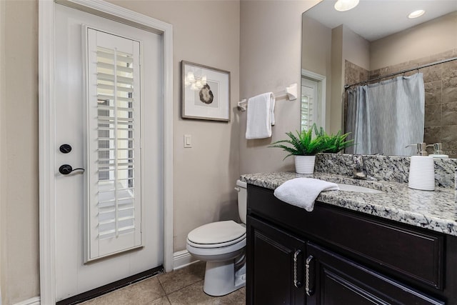 bathroom featuring tile patterned flooring, vanity, a shower with shower curtain, and toilet