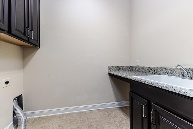 clothes washing area featuring sink, cabinets, and hookup for an electric dryer