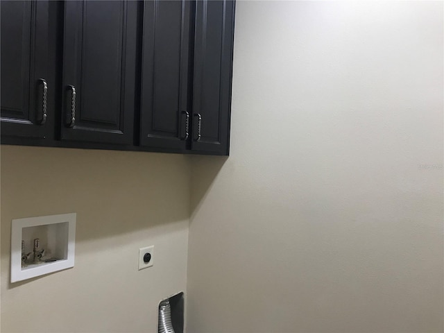 clothes washing area featuring cabinets, hookup for an electric dryer, and hookup for a washing machine