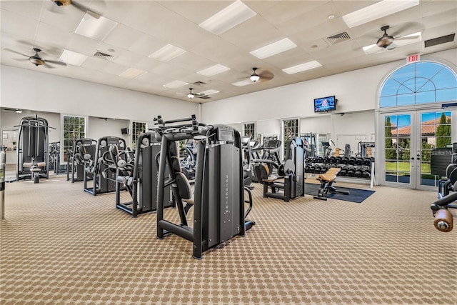 exercise room with carpet floors, ceiling fan, and a paneled ceiling