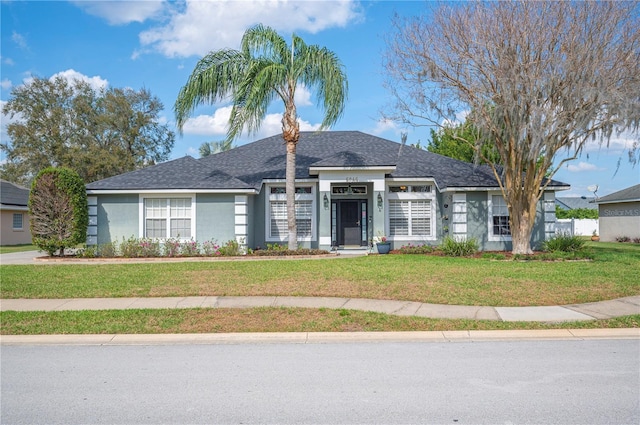 ranch-style home featuring a front lawn