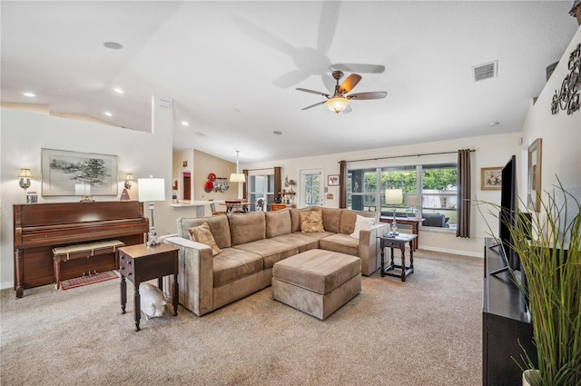 living room featuring ceiling fan, light colored carpet, and vaulted ceiling