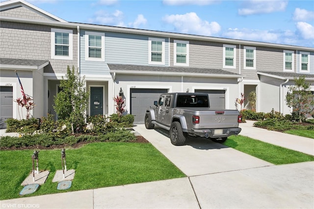 multi unit property featuring a garage and a front lawn