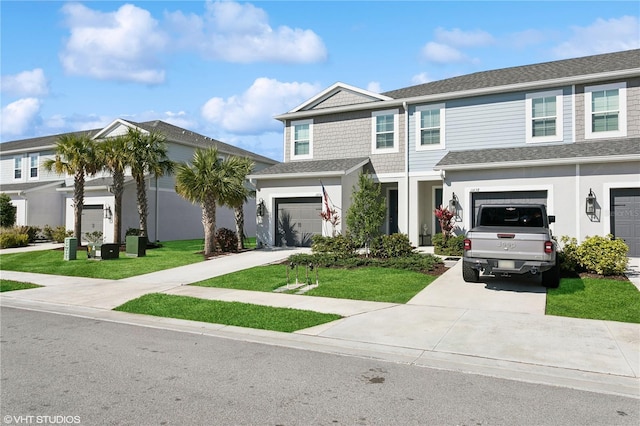 view of front of property featuring a garage and a front lawn